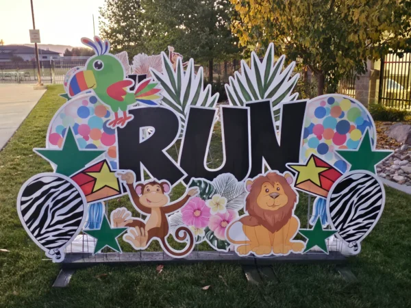 A yard sign that says "RUN" in black letters. Colorful graphics of animals surround the sign.