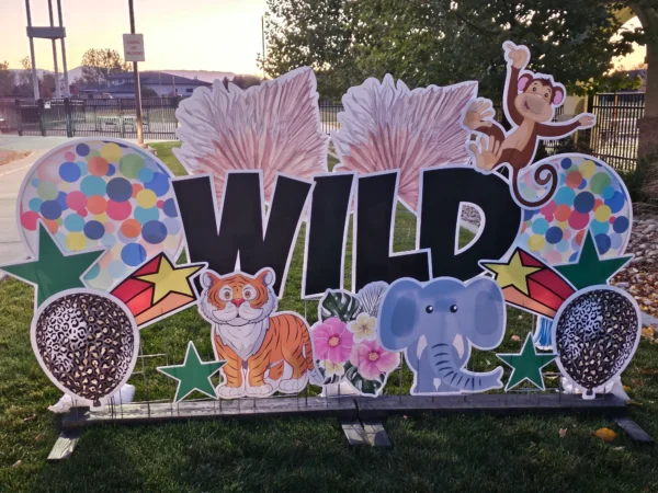 A yard sign that says "WILD" in black letters. Colorful graphics of animals surround the sign.