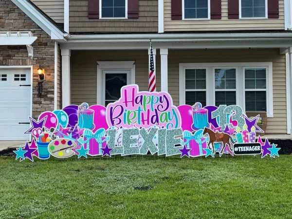 A yard sign in front of house that says "Happy Birthday Lexie" 13 in colorful letters. Colorful graphics surround the sign.