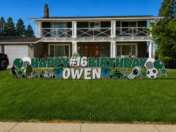 A yard sign in front of a house that says "HAPPY #16 BIRTHDAY OWEN" in green and white letters with colorful graphics surrounding the sign.